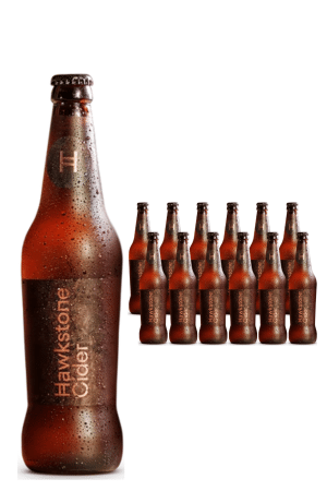 Tall foreground bottle of Hawkstone Cider with a row of smaller bottles behind it, all condensation-coated.